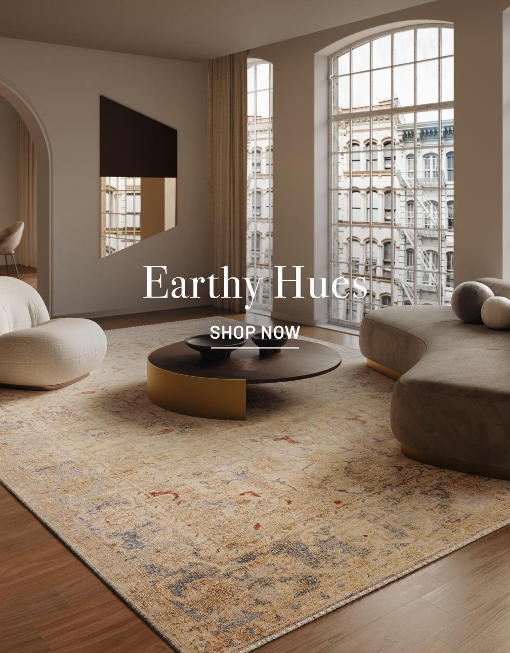 Modern elegant living room with designer rug, couch, table and chair.
TEXT overlay in white: "Earthy Hues" with SHOP NOW below it.